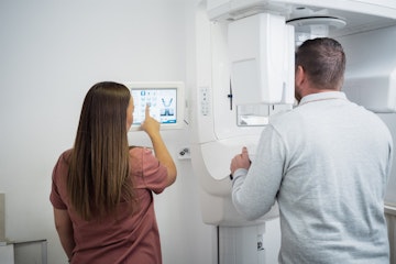 Nurse using the CT Scanner with a dental patient