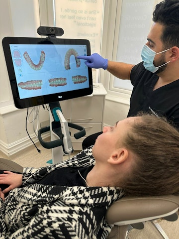 Invisalign patient being shown the treatment by a dentist
